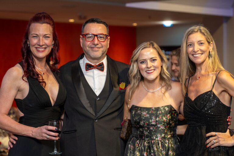 Four guests smiling together
