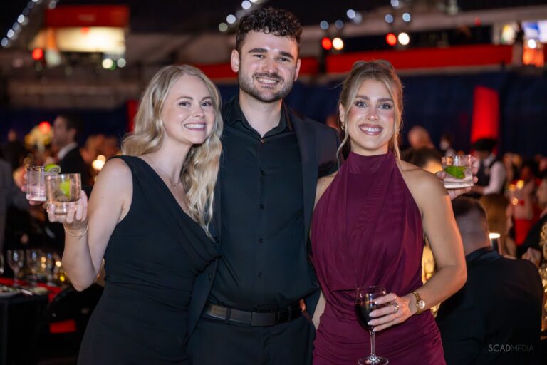 Three guests holding drinks